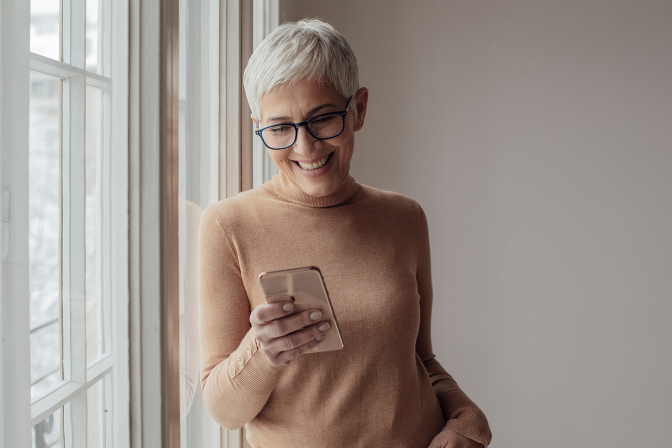 Pretty Senior Woman Typing on her Cell Phone
